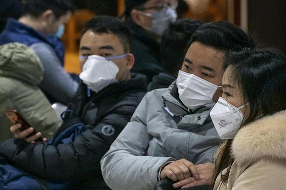 Ciudadanos chinos protegidos con mascarillas | Foto: EP
