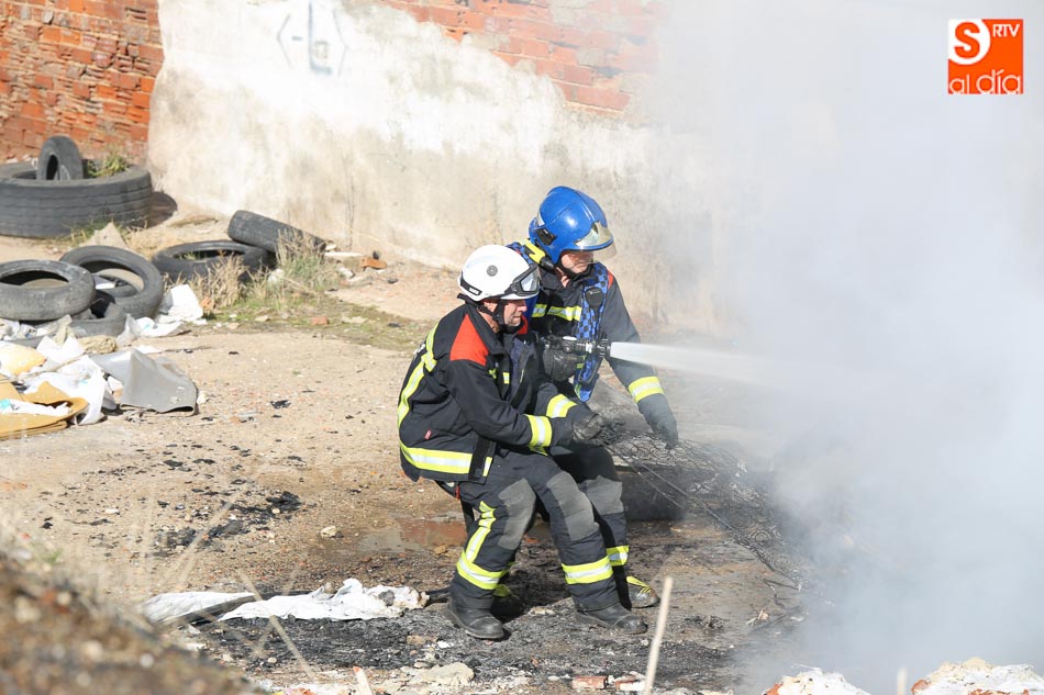 Dos bomberos sofocan un incendio en Tejares. Fotos: Alberto Martín
