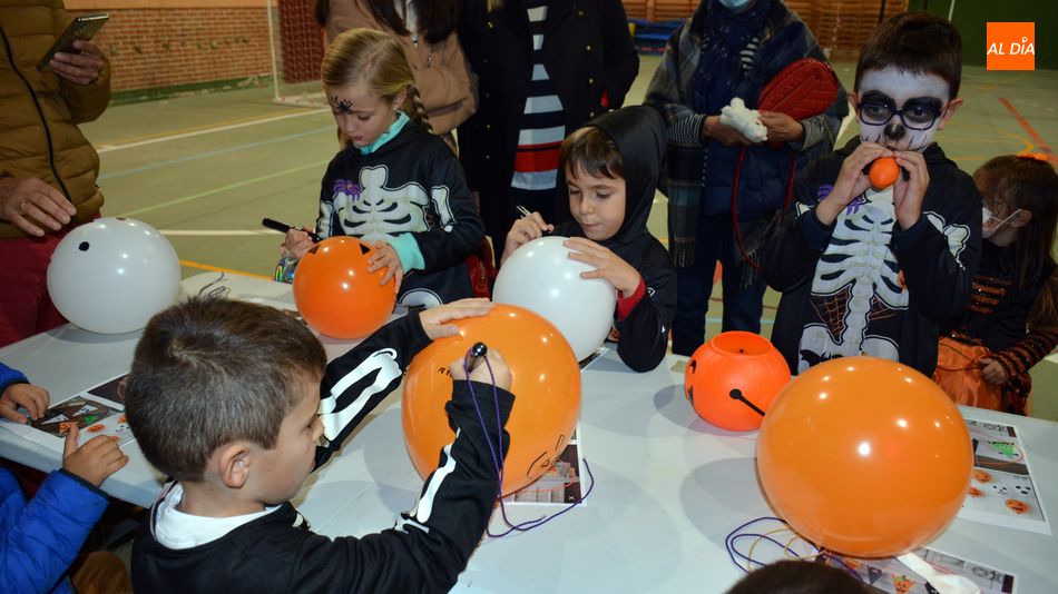 Un grupo de niños pintado globos con motivos de Halloween y sus nombres / E. Corredera