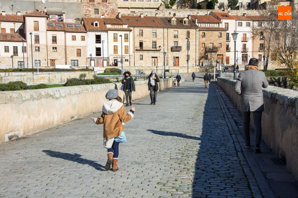 Varias personas paseando por el Puente Romano de Salamanca
